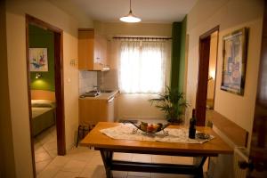 a kitchen with a table with a bowl of fruit on it at Marika House in Stavros