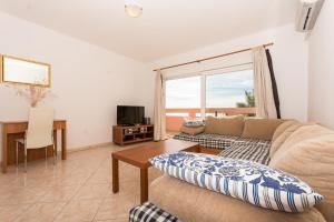 a living room with a couch and a table at Apartment Pavic-Nikic in Trogir