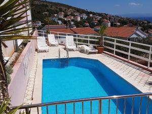 a swimming pool on the balcony of a house at Apartment Pavic-Nikic in Trogir