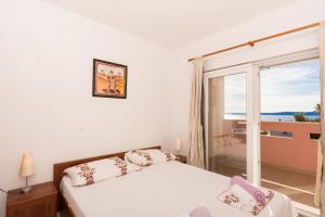 a bedroom with a bed and a large window at Apartment Pavic-Nikic in Trogir +34 photos