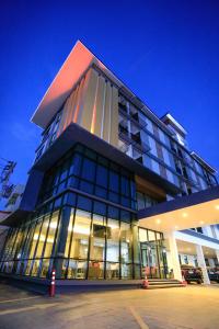 a large building with a lot of windows at night at Khonkaen Residence in Khon Kaen