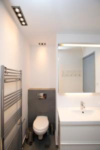 a bathroom with a toilet and a sink and a mirror at Beautiful Pelion Sea House in Kato Gatzea