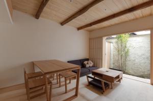 a living room with a table and a couch at BenTen Residences in Kyoto