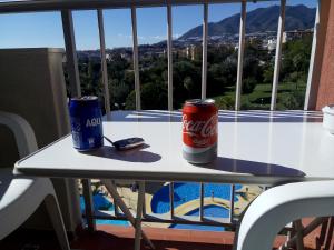 two cans of soda sitting on a table on a balcony at Jupiter Sea View in Benalmádena