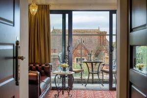 a room with a balcony with a view of a building at The George Street Hotel in Oxford