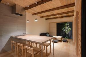 a kitchen and dining room with a table and chairs at BenTen Residences in Kyoto