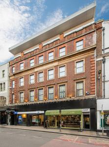 a large brick building on a city street at The George Street Hotel in Oxford
