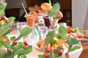 a table topped with plates of food and fruit at Hotel Central in Bad Sooden-Allendorf