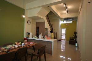 a dining room and kitchen with a table and chairs at Coffee Tree in Lukang