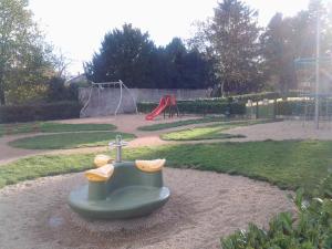 a park with a playground with a slide at Les Calaubys in Huriel