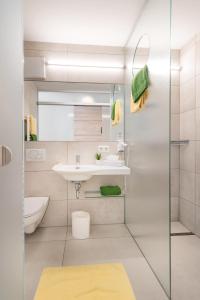 a bathroom with a sink and a shower at Parkhotel Pfarrkirchen in Pfarrkirchen