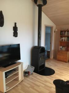 a living room with a wood stove in the corner at Three-Bedroom Holiday Home in Ebeltoft in Ebeltoft