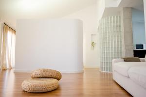 a living room with a white couch and a ottoman at Alojamientos Don Alvaro in Caravaca de la Cruz