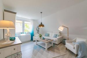 a living room with a couch and a table at Boddenhaus Darss in Wieck