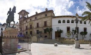 a large building with a statue in front of it at Hostal Colon Antequera in Antequera