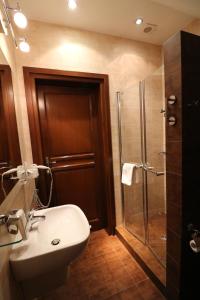 a bathroom with a shower and a sink and a toilet at Hotel Marzanna in Niedrzwica Kościelna