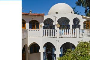 a large white house with a white balcony at Hotel La Cupula in Copacabana