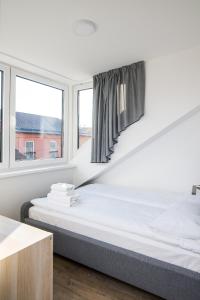 a bedroom with two beds and a window at Smartflat & New apartment city center in Kaunas