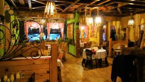 a restaurant with tables and chairs in a room at Elite Apartment Konaci in Kopaonik