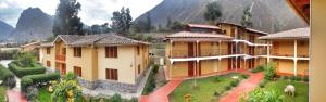 a group of buildings with mountains in the background at Tunupa Lodge Hotel in Ollantaytambo