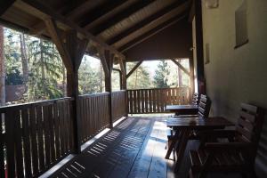 a screened in porch with two benches and a table at Lojzovy Paseky in Frymburk