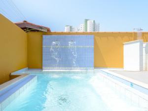 two dogs are standing in a swimming pool at Pousada Morada da Prainha in Caraguatatuba