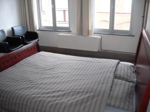 Postel nebo postele na pokoji v ubytování Guesthouse Oude Houtmarkt