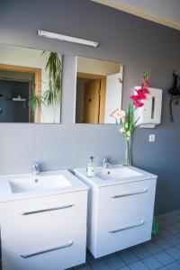 a bathroom with two sinks and a mirror at Guesthouse Hvammur in Höfn