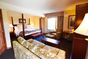 a hotel room with a bed and a couch and a bedroom at Arbors at Island Landing Hotel & Suites in Pigeon Forge +37 photos