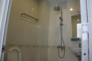a bathroom with a shower and a toilet and a sink at Sai Gon River Hotel in Ho Chi Minh City +17 photos