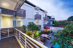 an outdoor balcony of a building with a fence at The Rinaya Canggu by ecommerceloka in Canggu