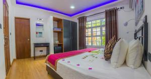 a bedroom with a large bed with a purple ceiling at Asaa View Maldives in Feridhoo