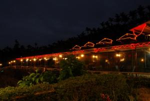 a building with lights on it at night at Ming Zhen Homestay in Gukeng