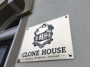a sign for a clone house on the side of a building at Clone Country House in Aughrim