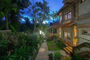 a house with a pathway leading to a yard at Ubud Terrace in Ubud