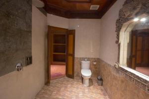 a bathroom with a toilet and a mirror at Ubud Terrace in Ubud