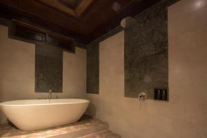 a bathroom with a white tub and a sink at Ubud Terrace in Ubud