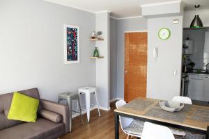 a living room with a couch and a table at Departamento Arrieros in Osorno