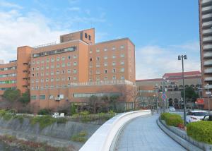 a building with a walkway in front of a building at Takarazuka Washington Hotel in Takarazuka