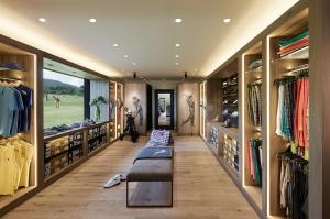 a dressing room with a bench in the middle at Margarethenhof am Tegernsee in Waakirchen +59 photos