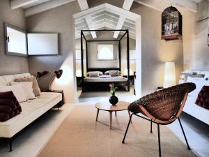 a living room with a couch and a mirror at Pianaura Suites in Marano di Valpolicella
