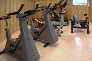 a gym with two exercise bikes and a treadmill at Hamarøy Hotel in Innhavet