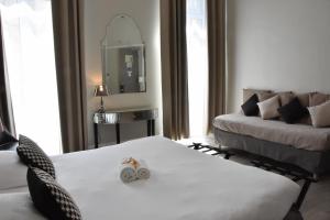 Postel nebo postele na pokoji v ubytování Régina Boutique Hotel