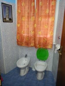 a bathroom with a toilet and a bidet at Roxena house in Rome