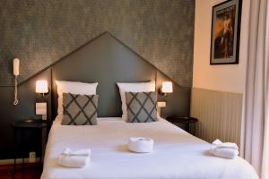 Postel nebo postele na pokoji v ubytování Régina Boutique Hotel