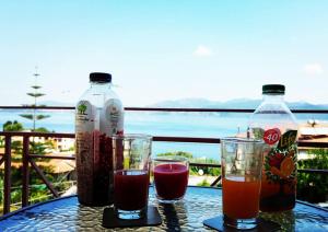 a table with two bottles of juice and two glasses at Christianna Studios in Nikiana
