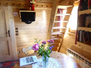 a vase of flowers on a table in a room at Chalet Fleur des Neiges in Saint-Jean-dʼAulps
