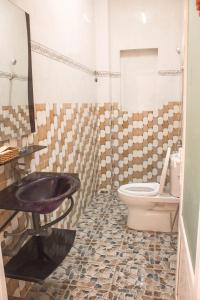 a bathroom with a sink and a toilet at Yen Ngoc Guesthouse in Da Lat