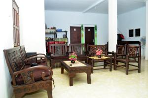 a group of chairs and tables in a room at Sritanjung Homestay in Banyuwangi