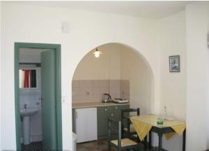 a kitchen with a table and a table and a dining room at Elgini Studios in Plakias